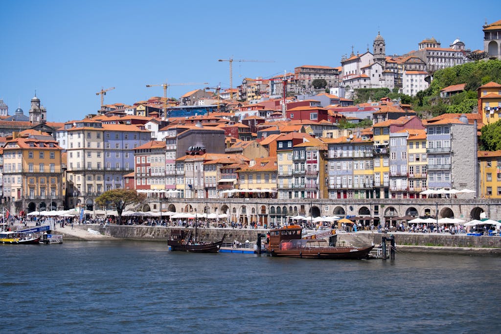 Home 2 colorful waterfront view of ribeira district portos historic charm under a bright sky. 32053039 scaled